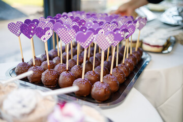 Delicious heart-shaped cake pops displayed at a festive dessert table