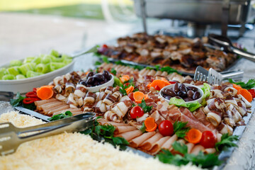 Deliciously arranged charcuterie board featuring meats, cheese and fresh vegetables at a celebration