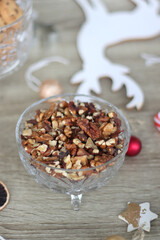 Various Christmas decorations, cookies, chocolate and nuts on wooden background. Selective focus.