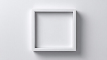 Empty white frame on a plain wall ready for artwork or display