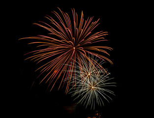 Fireworks explosions against black night sky