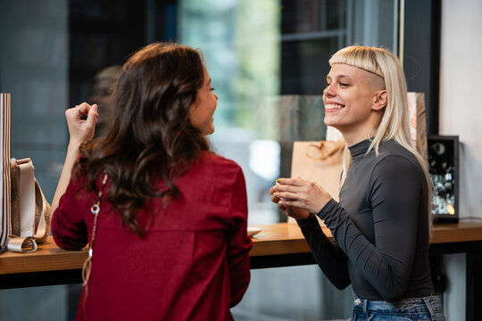 Two young women enjoying a conversation in a cafe