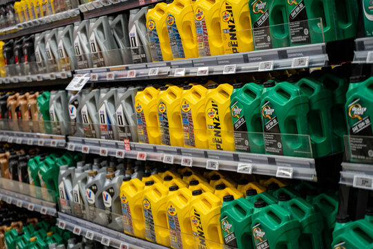 Row of motor oil containers on automotive aisle shelf. Brampton, Canada - November 16, 2025.