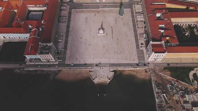 Aerial view of the vast, sun-drenched Praca do Comercio square, framed by grand buildings and the Tagus river, Lisbon, Lisbon, Portugal.