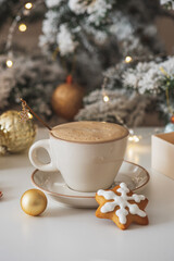 Cup of Hot Coffee with Christmas Gingerbread Cookies and Ornaments in Festive Setting