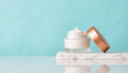 Cream jar with lid on marble surface against blue background  