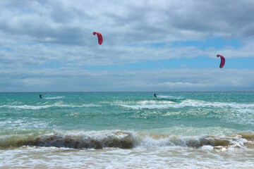 Kitesurfers Riding Waves at Sotavento Beach, Fuerteventura on a Sunny Day