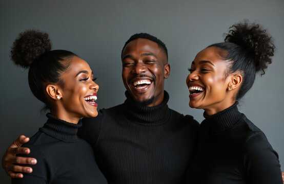 Two young Black women, one man laugh heartily together in studio setting. Share moment of pure joy, connection, dressed in elegant black turtlenecks. Smiles bright, eyes sparkle with happiness. Photo - Powered by Adobe