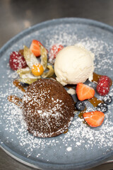 Warm chocolate cake served with ice cream and fresh berries.