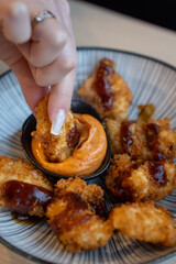 Plate of nuggets with dipping sauce on table