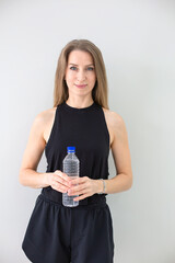 Healthy Woman in Sportswear Holding Water Bottle