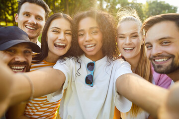 Portrait of happy friends take selfie together with phone for social media outdoors in city park, capturing party moments, enhancing togetherness in a space filled with digital connection and sharing.