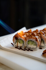 Sushi Rolls Torched with Flame on White Plate.