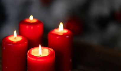 candles burning against holiday lights background