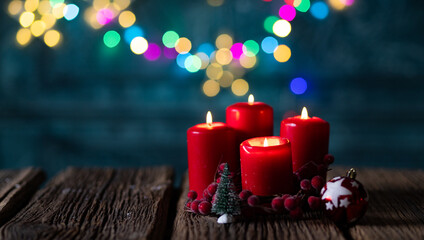 candles burning against holiday lights background