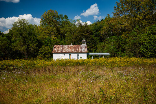 Abandoned and Historic Chapel surrounded by Wildflowers and Forest - Appalachia - Ohio - Powered by Adobe