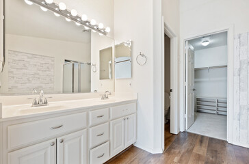 Stylish Modern Bathroom with Dual Sinks and Walk-In Closet
