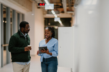 Business colleagues discussing project ideas using a tablet
