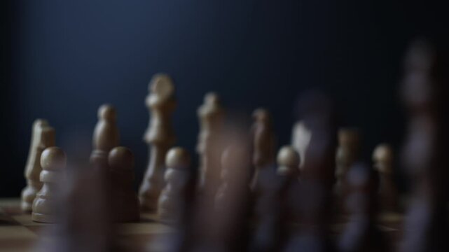 Moving footage of chess pieces on a spinning game board, illustrating the strategic confrontation between opposing black and white armies in mental combat.