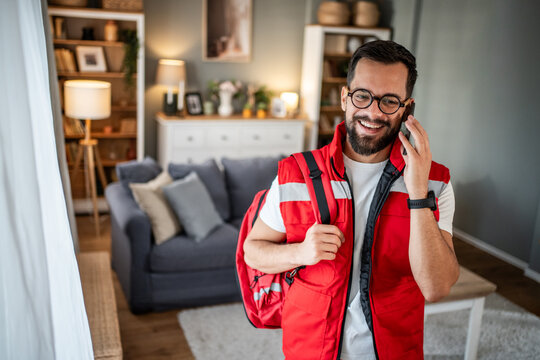 First responder paramedic smiling during home visit call - Powered by Adobe