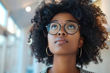 Young woman looking up with curiosity in a bright room