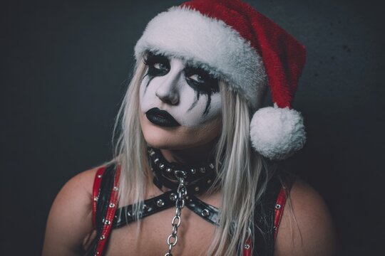Woman in Santa Hat with Black Metal Makeup and Leather Harness