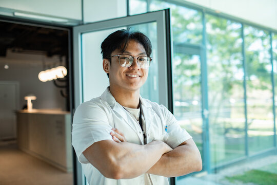 Young adult healthcare professional smiling confidently in modern clinic