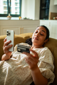 Adult woman focused on online payment at home