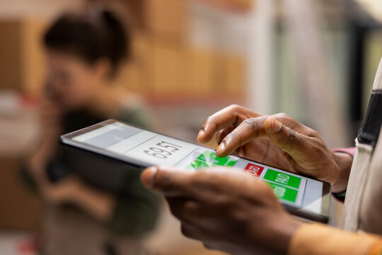 Close up of staff member handling cargo preparation in a small scale warehouse, focusing on e-business operations, product retail processing and express delivery for online shopping.