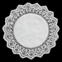 Round white lace doily on black background close up