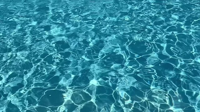 Rippling shiny water surface in swimming pool. Slow motioR