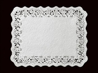 White rectangular paper lace doily on dark background