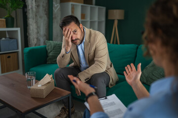 Man feeling sad during therapy session with psychologist