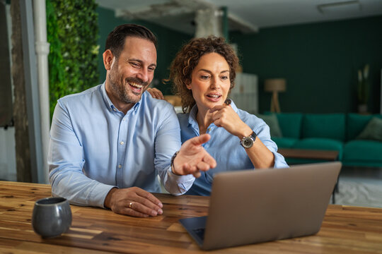 Couple having a happy video call on laptop at home