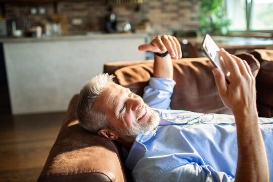 Mature man smiling during video call at home