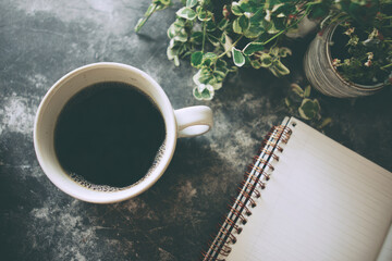 Coffee cup recycled notebook green plant workspace eco friendly morning relaxation writing desk natural light. cozy eco friendly workspace with coffee cup recycled notebook and green plant