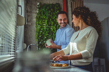 Coworkers enjoying coffee break and friendly conversation