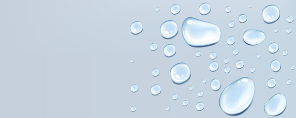 Blue transparent raindrops on a soft blue background with realistic flowing texture.
