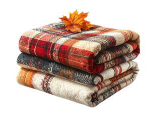 Folded plaid blankets stack with autumn leaf on top