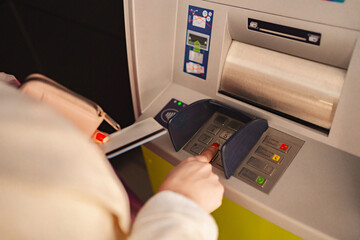 Using an ATM to withdraw cash in a busy urban setting