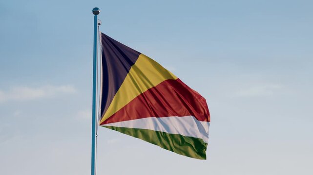 Seychelles, Victoria: Cinematic Waving National Flag Against Blue Sky