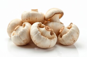 Fototapeta premium Pile of champignons on white. Edible raw agaricus closeup. Gourmet fungi for french cuisine. Fresh organic food ingredients. Studio shot of raw brown champignon. Healthy diet meal.