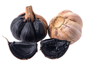 Black, white garlic bulbs, sliced open. Dark, pale bulbs