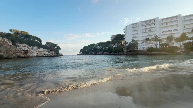 Sunset on Cala Ferrera beach in Cala D'Or village in Mallorca, Spain panoramic view.
