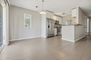 A kitchen and dining room with stainless steel appliances