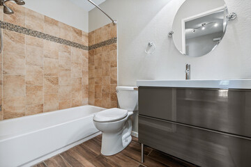 This is a bathroom that includes a toilet, sink, bathtub, and a mirror