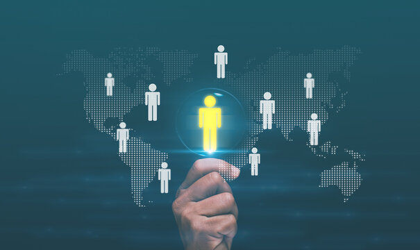 Human resources management concept. Manager holding magnifying glass with highlighted person icon. Recruitment, team management and international talent connection in modern digital business.