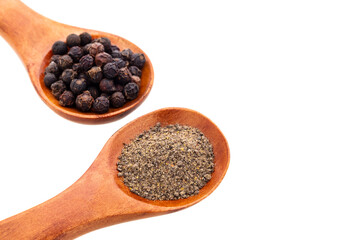 Black peppercorns in two wooden spoons - Piper nigrum