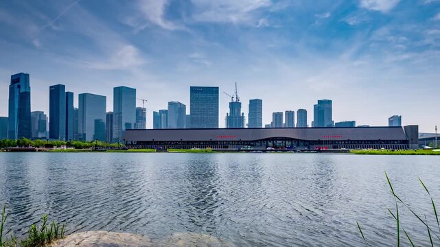 A row of modern high-rise buildings parallel to the lake