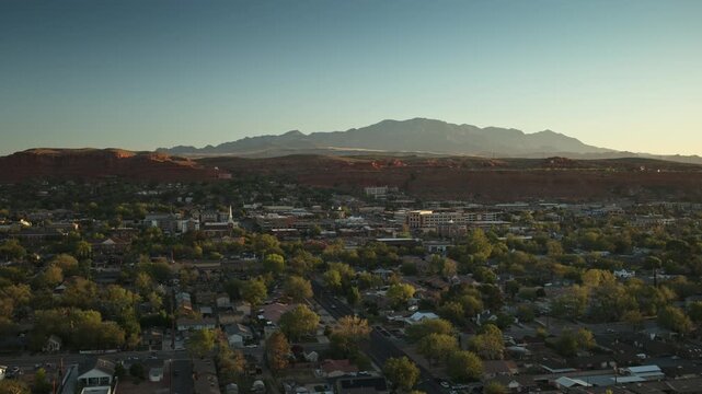 Aerial flyover of central St. George, Utah in the early morning on a clear day with blue sky